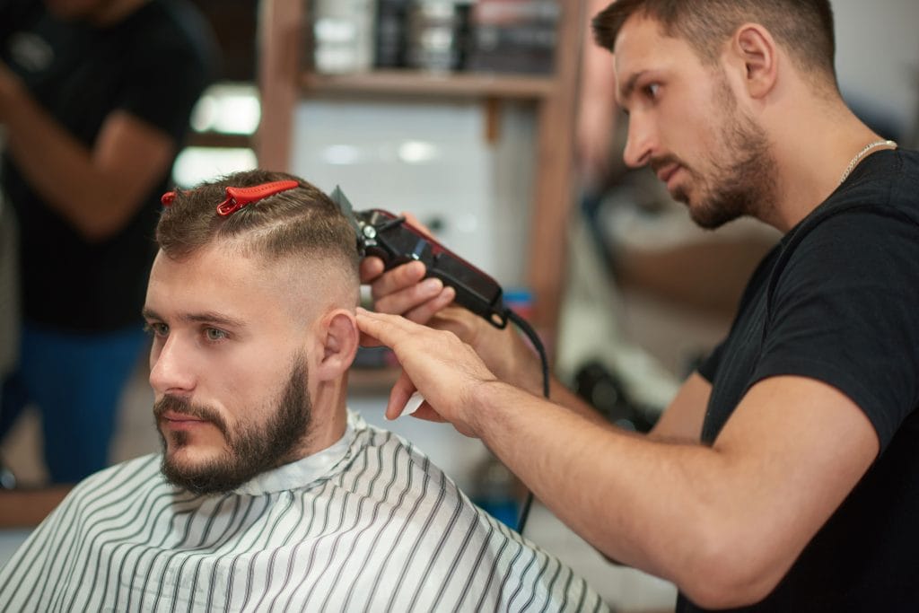 40 Perfect Low Taper Fade Haircuts For Men 12 A bold high taper fade haircut, featuring a dramatic taper that starts higher on the sides and back, blending into longer hair on top for a striking contrast and modern edge.