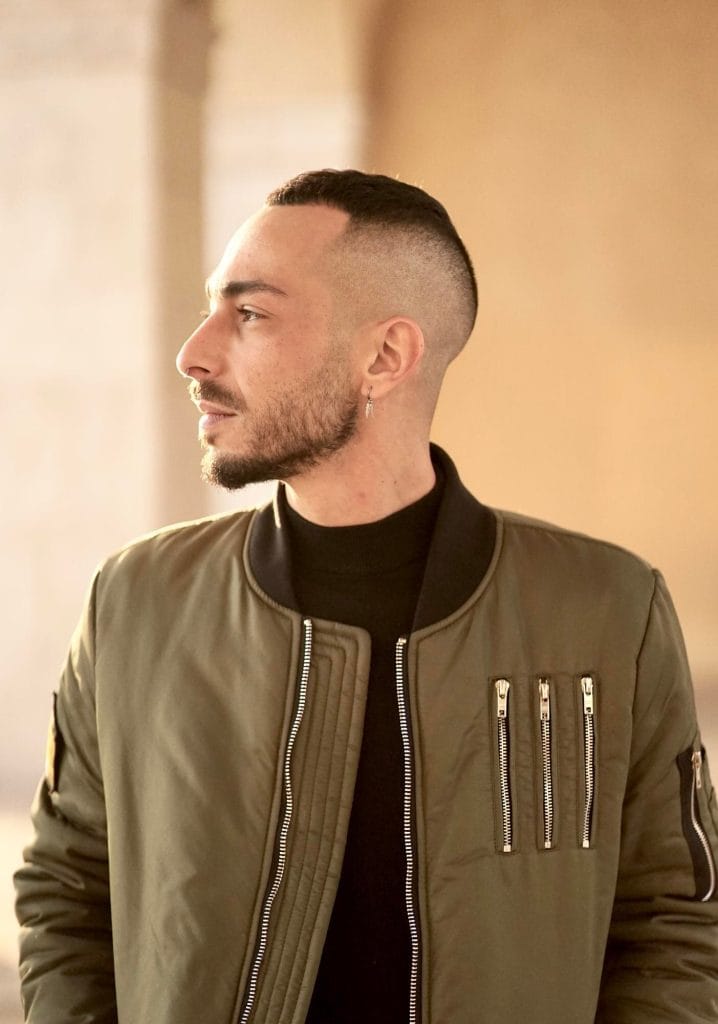 10 Best Ideas High Taper Fade Haircut For men 5 Man with short hair styled in a high taper fade, featuring a sharp fade above the temples and a clean, textured look on top.
