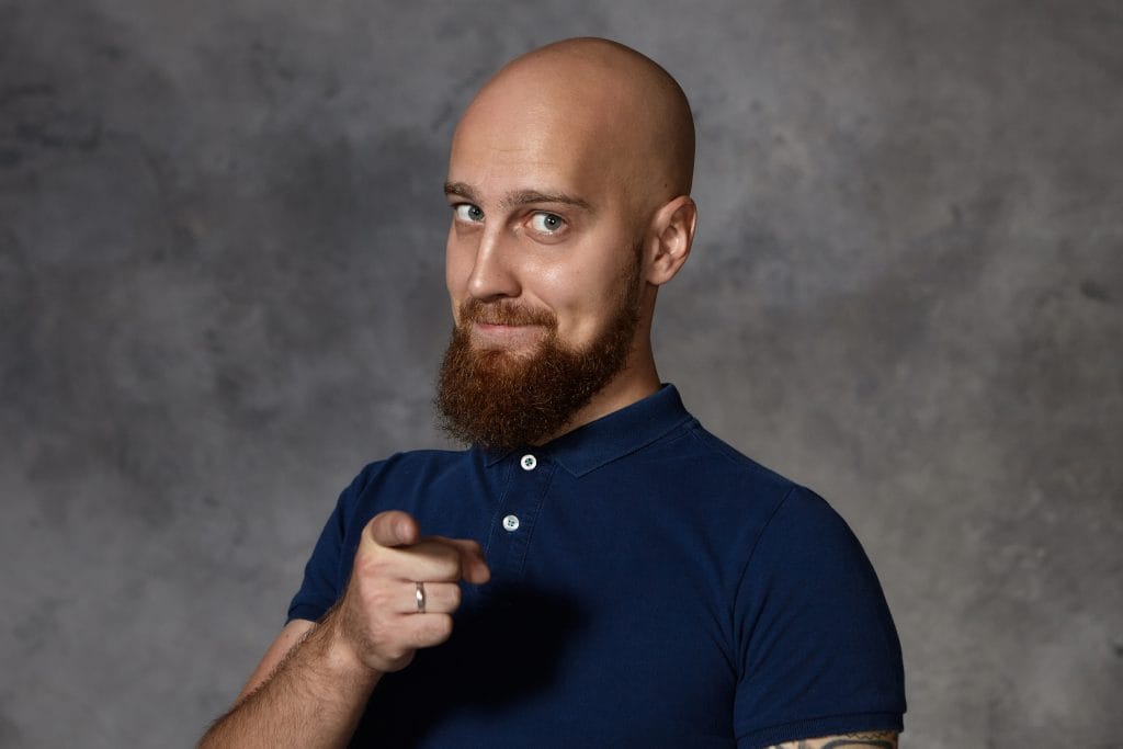 6 Buzz Cut Styles To Know Before Shave Your Head 5 A man with a buzz cut paired with a well-groomed beard, showcasing a perfect blend of clean-cut style and rugged masculinity. The look is modern, balanced, and effortlessly stylish.