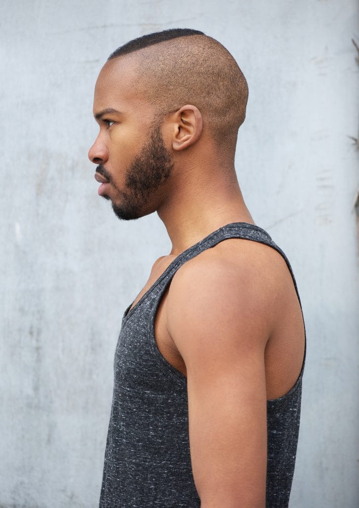6 Buzz Cut Styles To Know Before Shave Your Head 6 A man with a buzz cut low fade, showcasing a sharp and modern hairstyle where the hair gradually tapers near the ears and neck. The look is clean, polished, and effortlessly stylish.